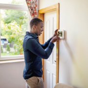 homeowner de-activating burglar alarm